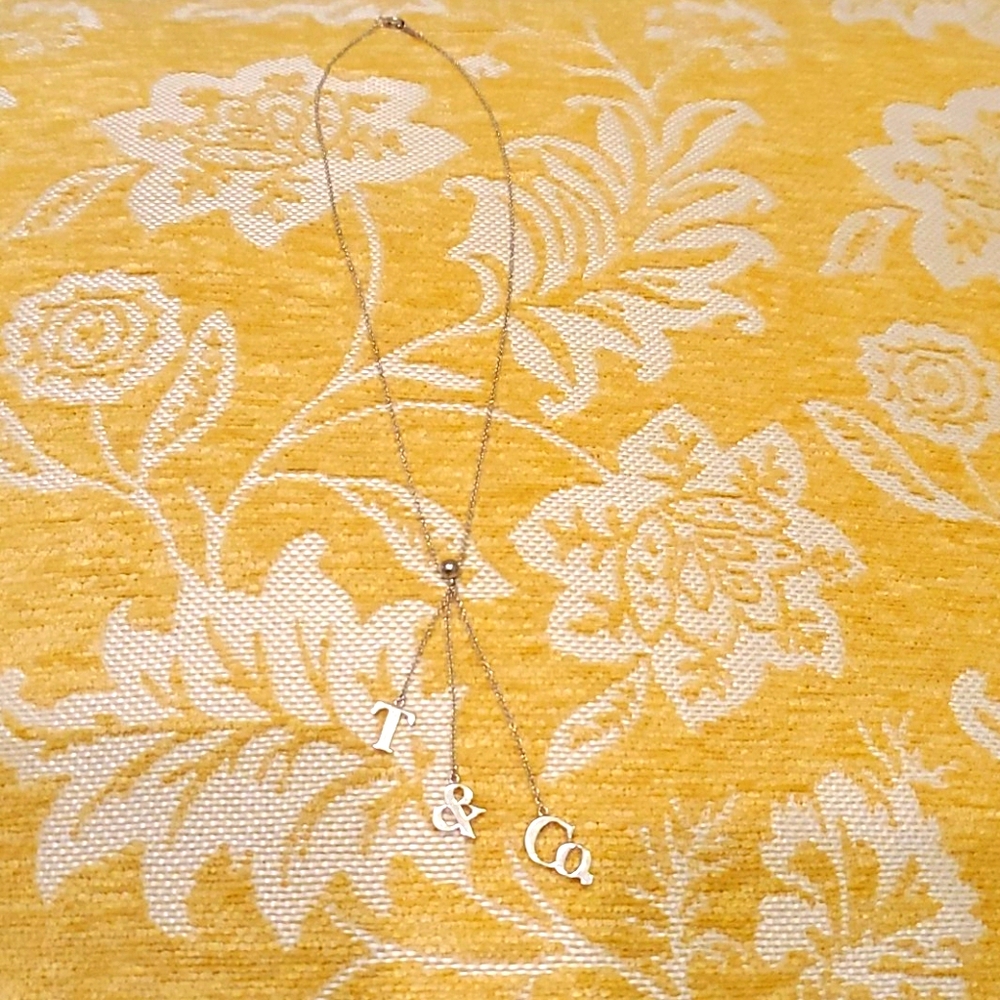 Tiffany & Co., silver T & Co. lariat necklace.
